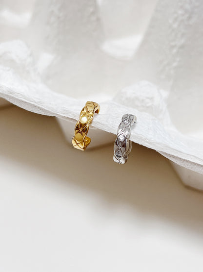 Close-up of gold Louie Quilted Ear Cuff showing deep-etched diamond texture.