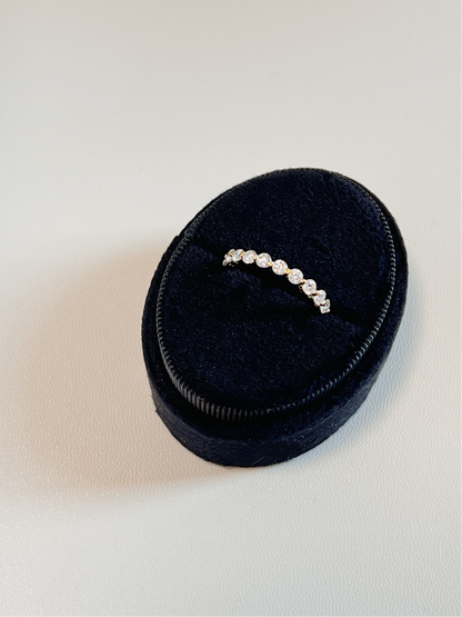 Close up perspective of a premium shared prong moissanite eternity band displaying a continuous loop of gems