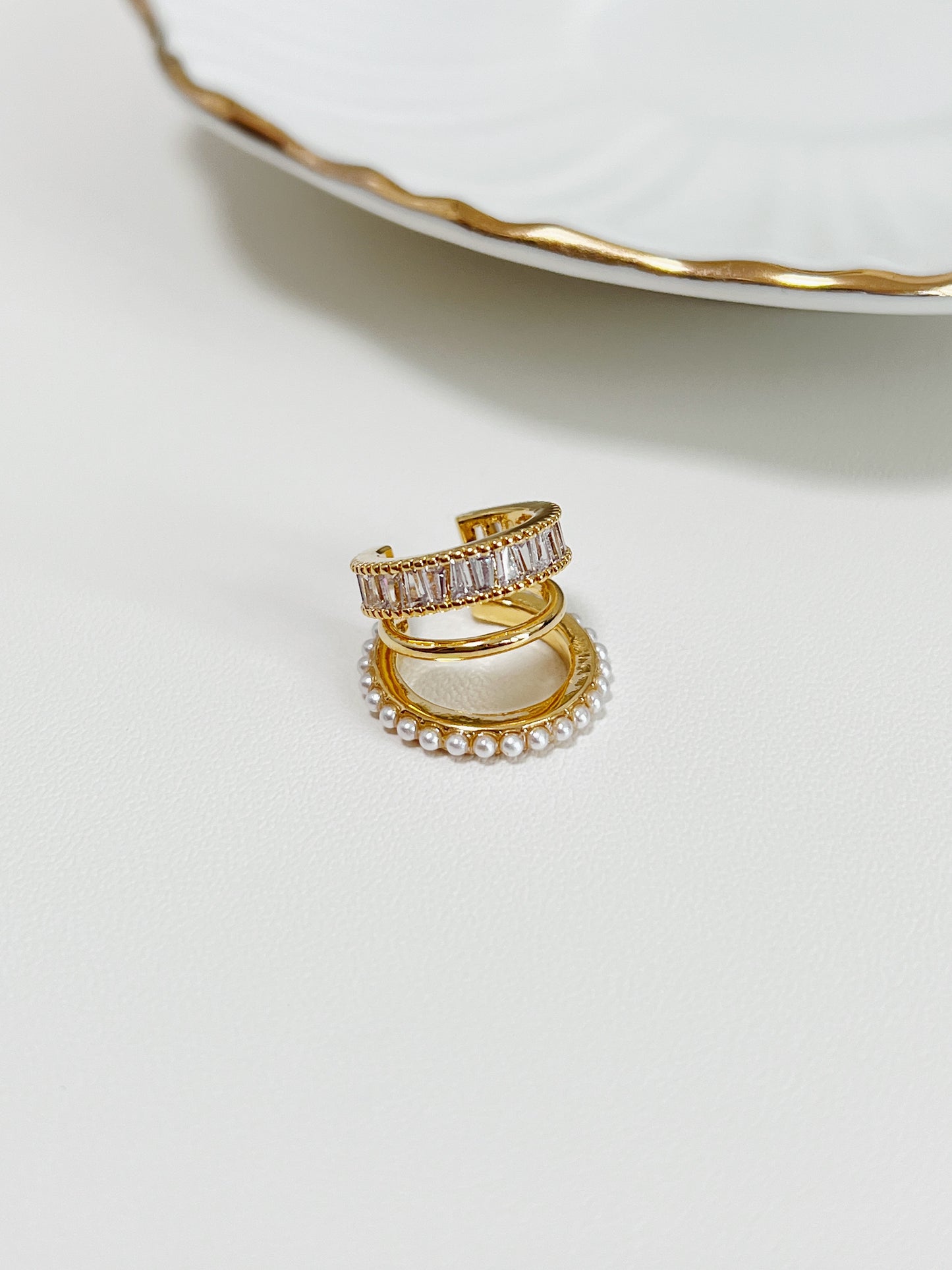 Close-up of Luxe Triple Ear Cuff featuring baguette CZ and pearls.