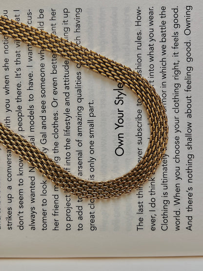 Luxury jewelry catalog presentation displaying the flat profile of a wide stainless steel base collar