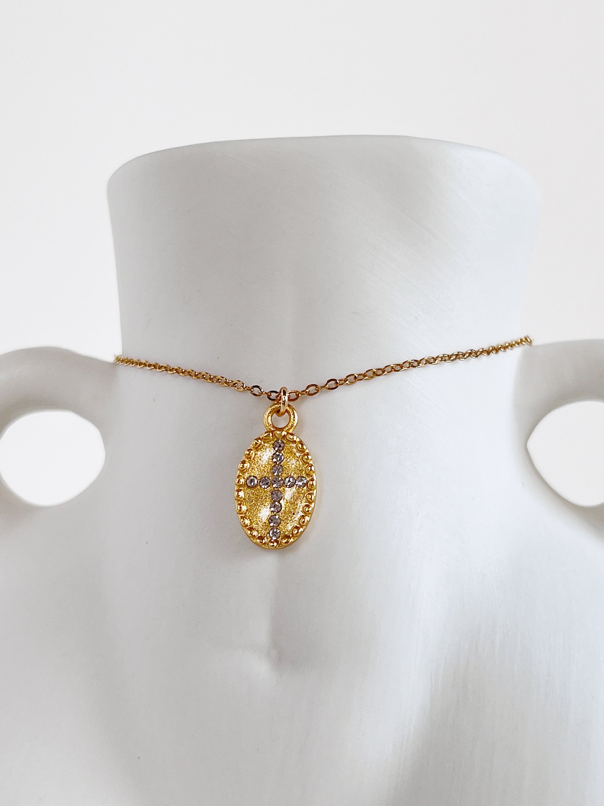 Macro jewelry photography highlighting the crystal cross centerpiece and beaded border of the Gianna necklace