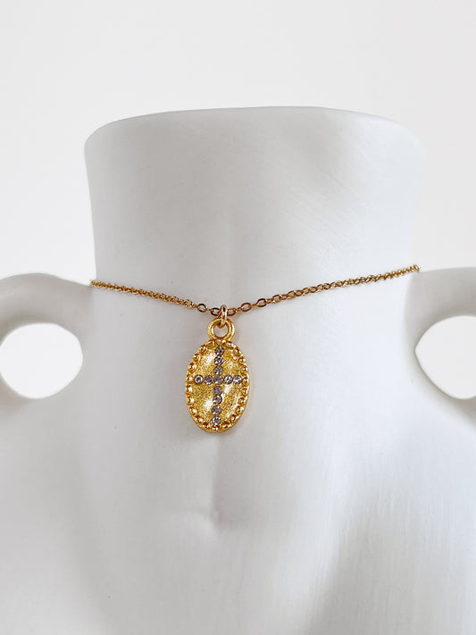 Macro jewelry photography highlighting the crystal cross centerpiece and beaded border of the Gianna necklace