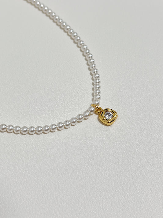 Macro jewelry photography capturing light refracting through a brilliant-cut cubic zirconia charm inside a molten bezel frame