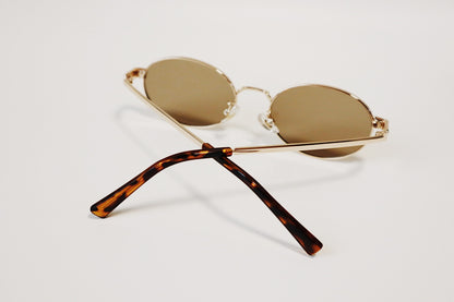 Macro view of the Marseille sunglasses showcasing the rich tortoiseshell acetate ear tips and the precision hinge construction.