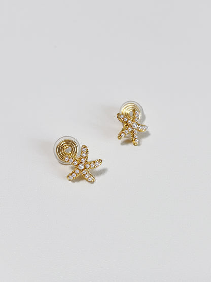 Technical view showing the gold-plated spiral spring coil clips and clear silicone comfort pads on the back of the non-pierced starfish earrings.