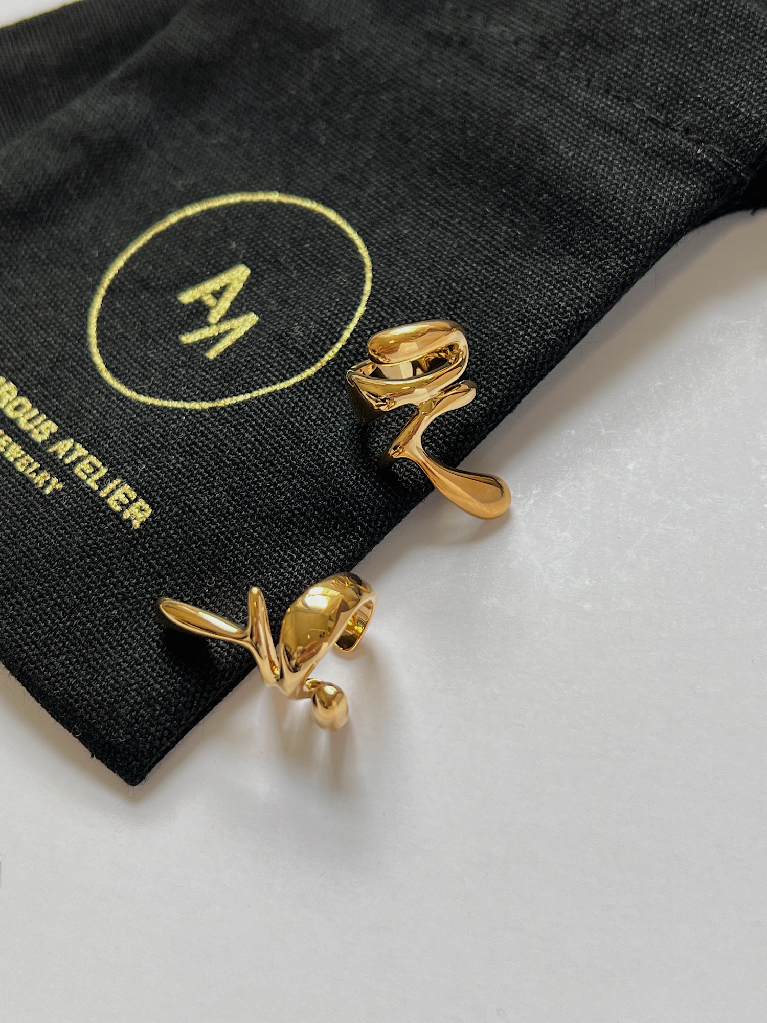 Close-up of the high-mirror shine on a waterproof 18K gold PVD ear cuff.