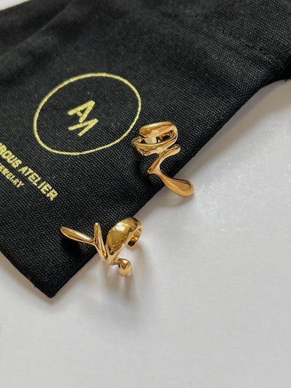 Close-up of the high-mirror shine on a waterproof 18K gold PVD ear cuff.