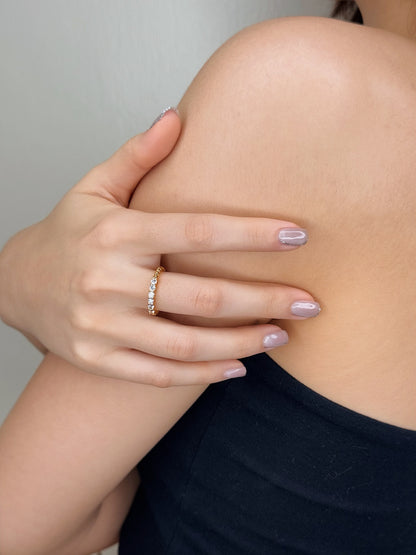 Womens hand showing a quiet luxury minimalist ring stack with a thin gold band