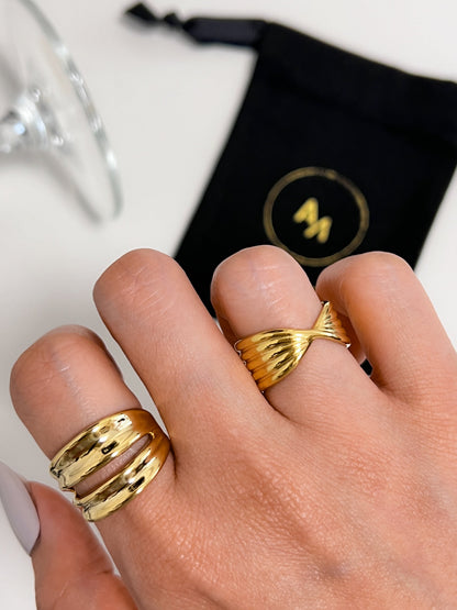 High end jewellery model photo showing a curated multi band stack on the hand