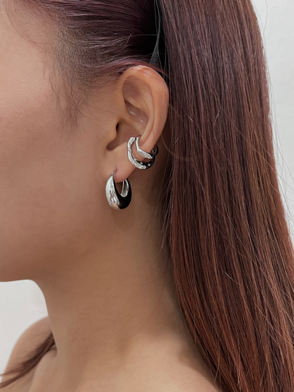 Multi-layered ear stack featuring Ashley Silver Cuff and silver hoops.