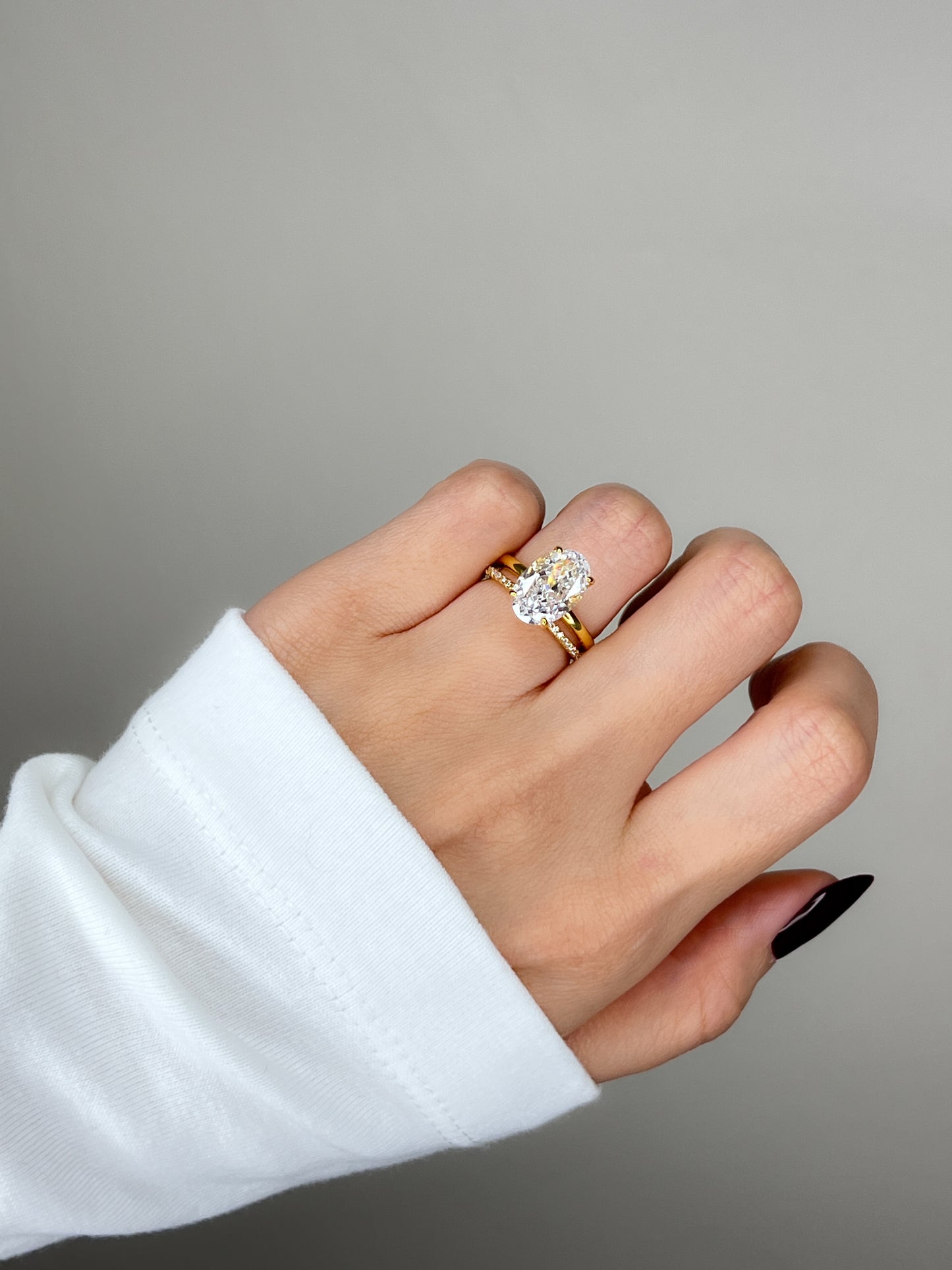 Luxury lifestyle shot of an influencer wearing a gold oval solitaire ring