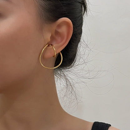 Model wearing the Kendra Gold Cuff at the mid-helix for a clean-look stack.
