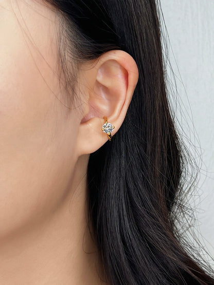 Model wearing round cut cuff on helix.