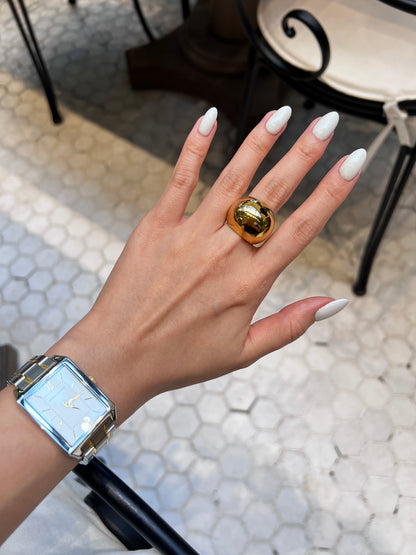 Top view of the uninterrupted fluid dome curves on the gold statement ring
