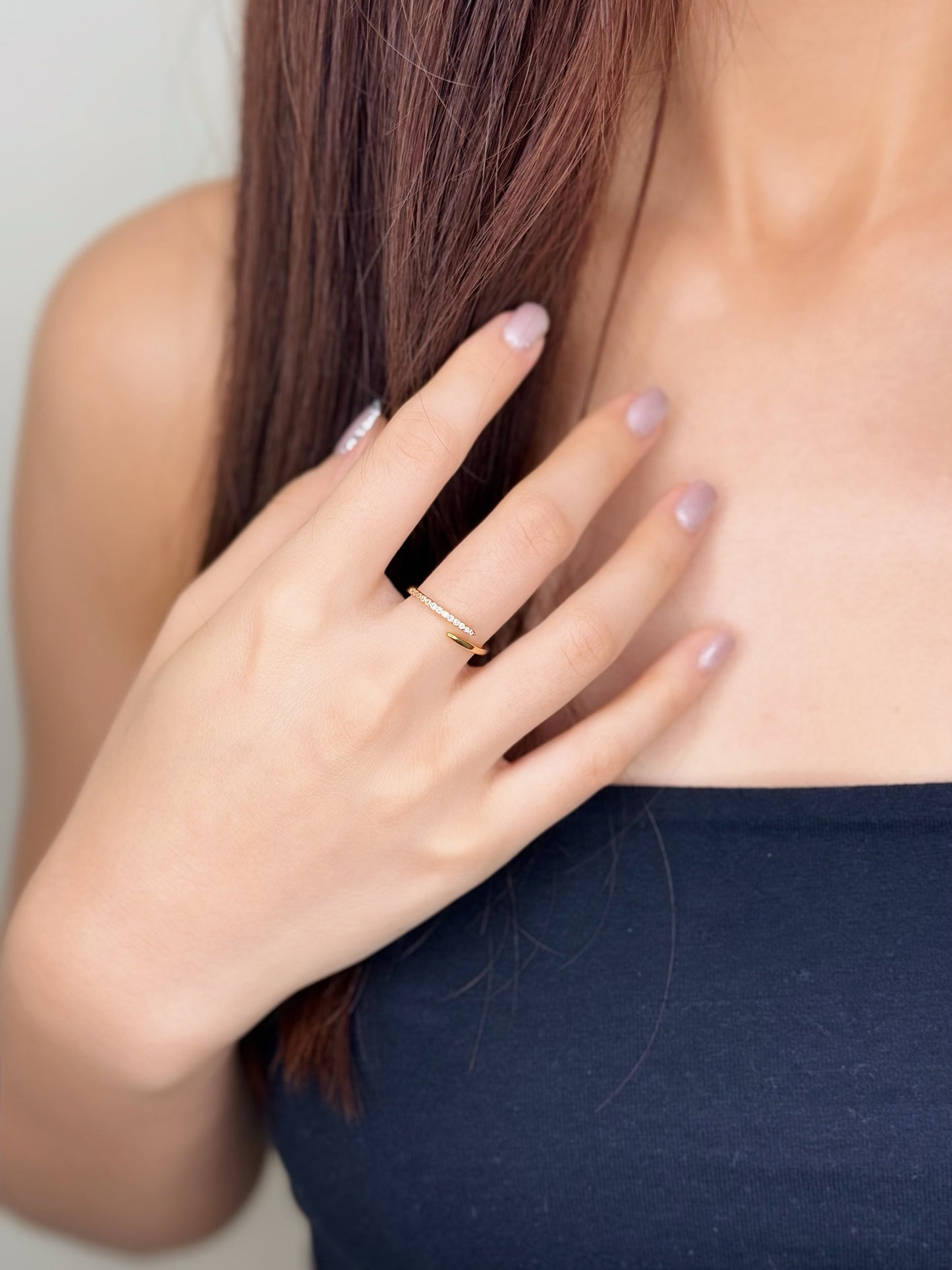 Model wearing the Ava diamond wrap ring on her middle finger with a black top