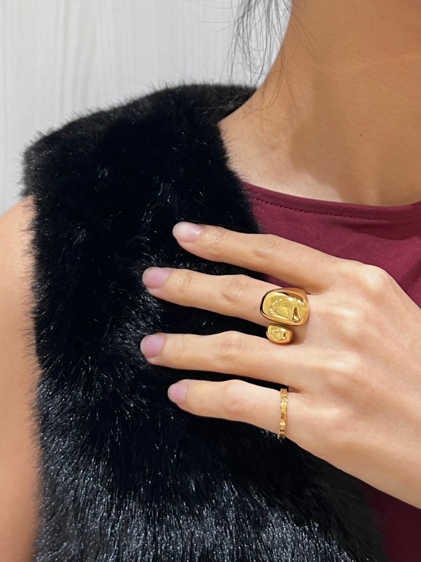 Model styling the Huda Bold Sculptural Ring on the middle finger