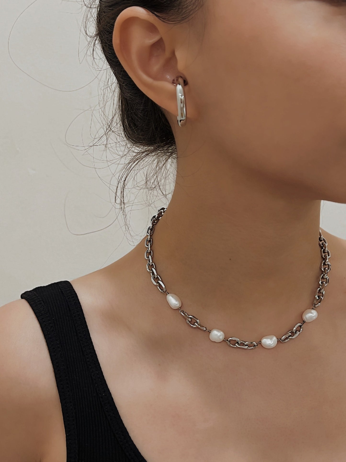 Model collarbone view styling lydia baroque pearl chain necklace over black top