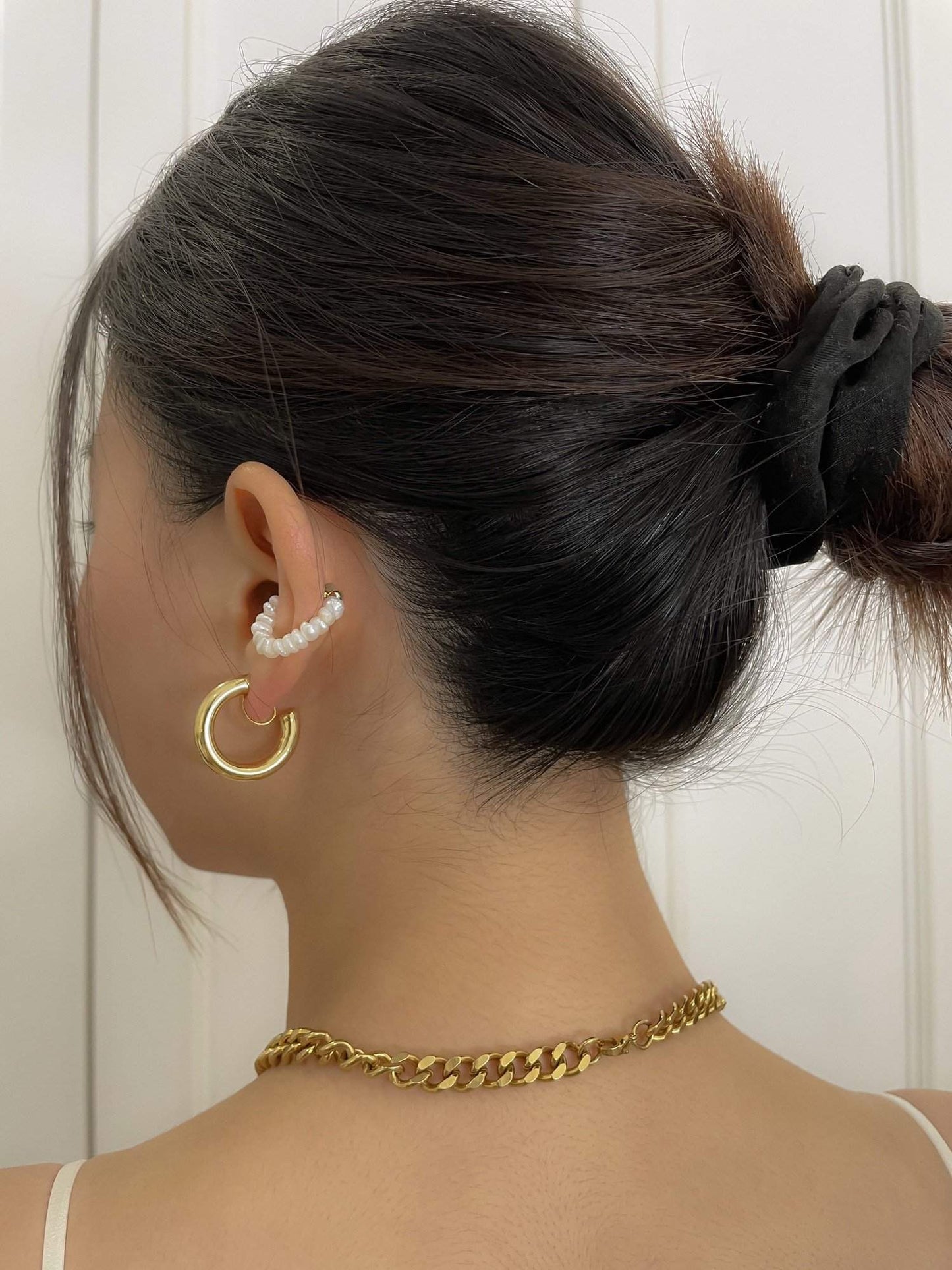 Side crop profile showing a clean comfort fit gold hoop clip sitting perfectly secure on a woman