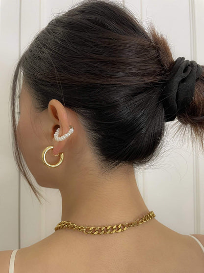 Side crop profile showing a clean comfort fit gold hoop clip sitting perfectly secure on a woman