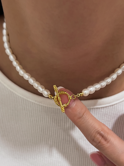 Model neck showing the fit of Madeleine pearl necklace resting beautifully above a white ribbed crewneck shirt