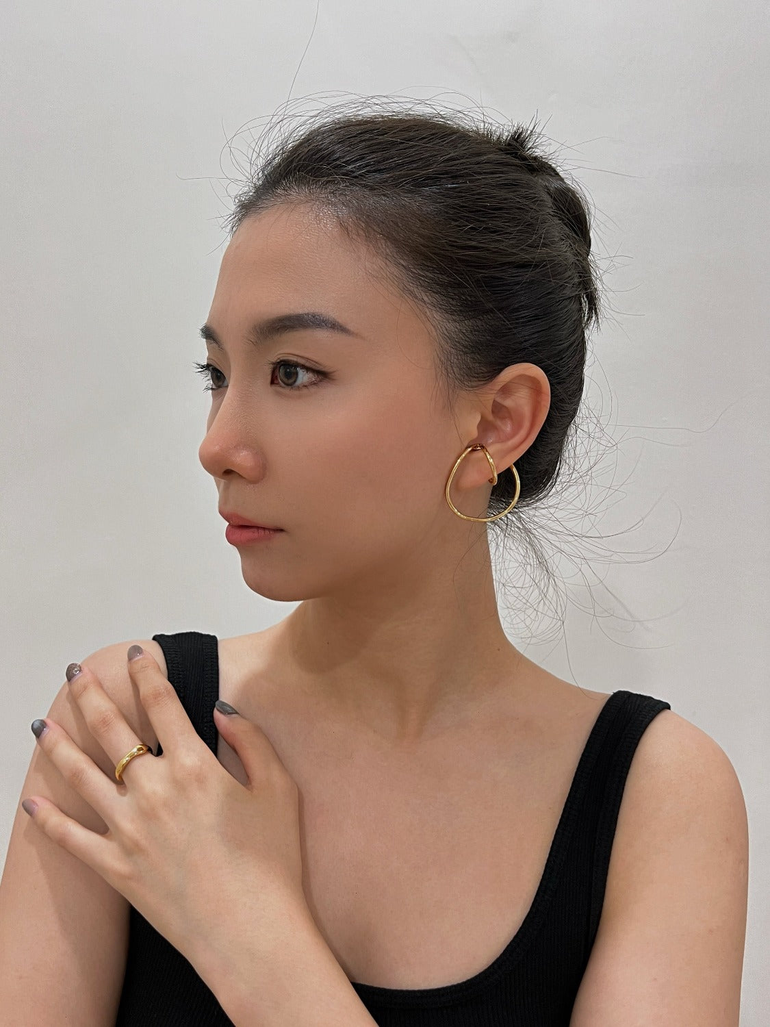 Model with a slicked-back bun highlighting the Kendra architectural cuff.