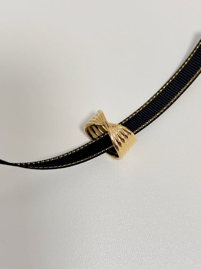 Detailed close up of 18k gold PVD ring highlighting its sculptural twist