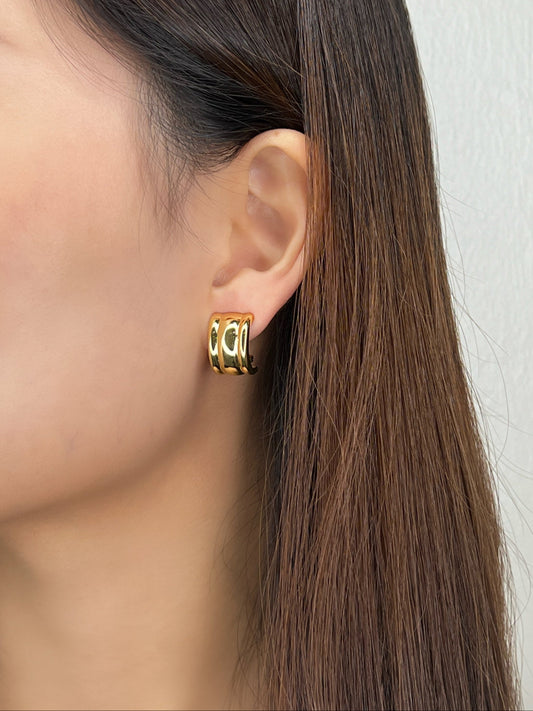 Close up of Model wearing Molly non-pierced ribbed clip-on earrings
