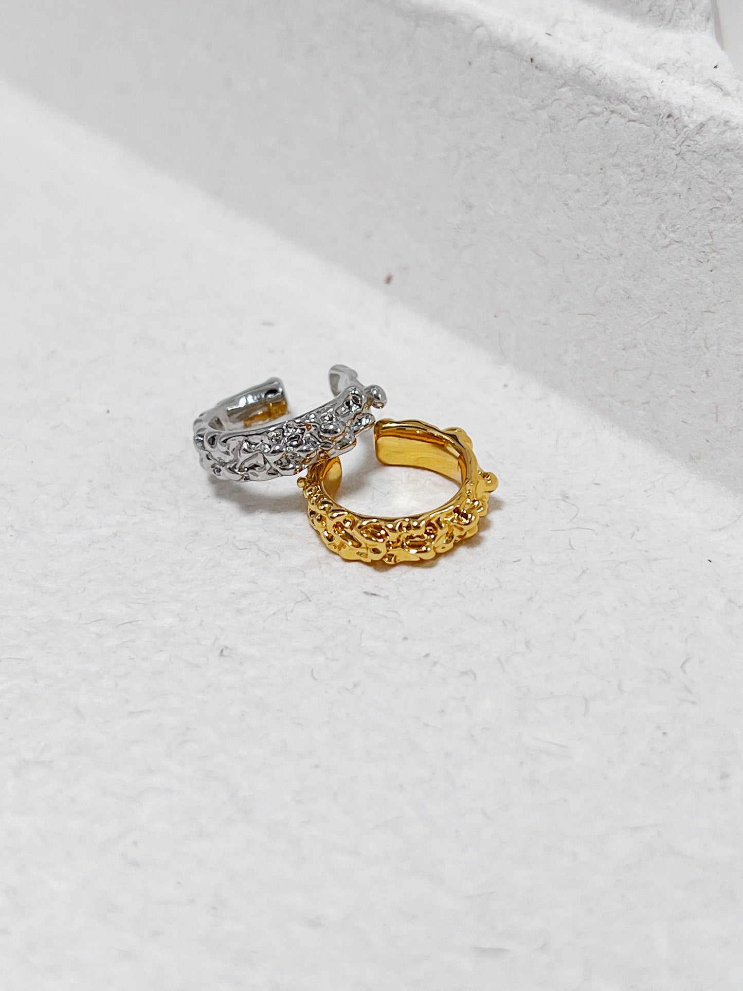 Close-up of the Molten Ridge sculptural ear cuff revealing the molten-like gold finish.