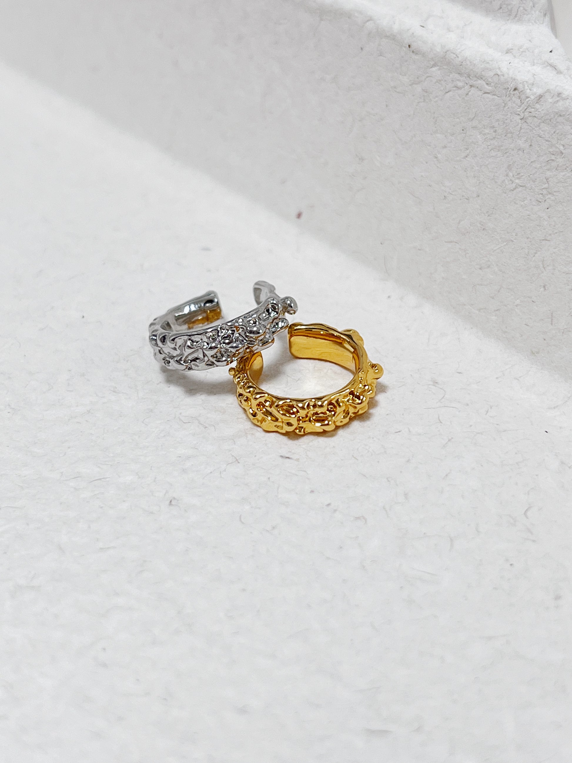 Close-up of the Molten Ridge sculptural ear cuff revealing the molten-like gold finish.