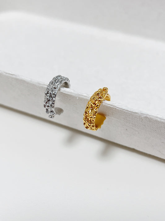 Molten Ridge ear cuff in 18k gold PVD, front view showing the organic cratered texture.