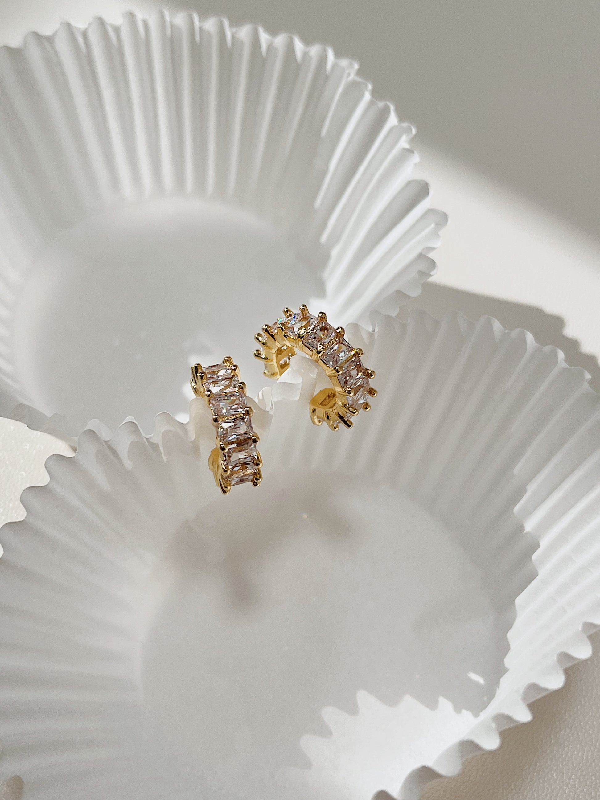 Close-up of the architectural baguette-cut cubic zirconia stones on a gold cuff.