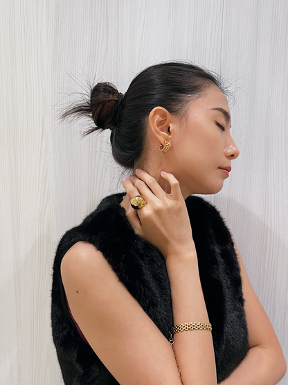 Model styling Mylie hoops with high-fashion attire.