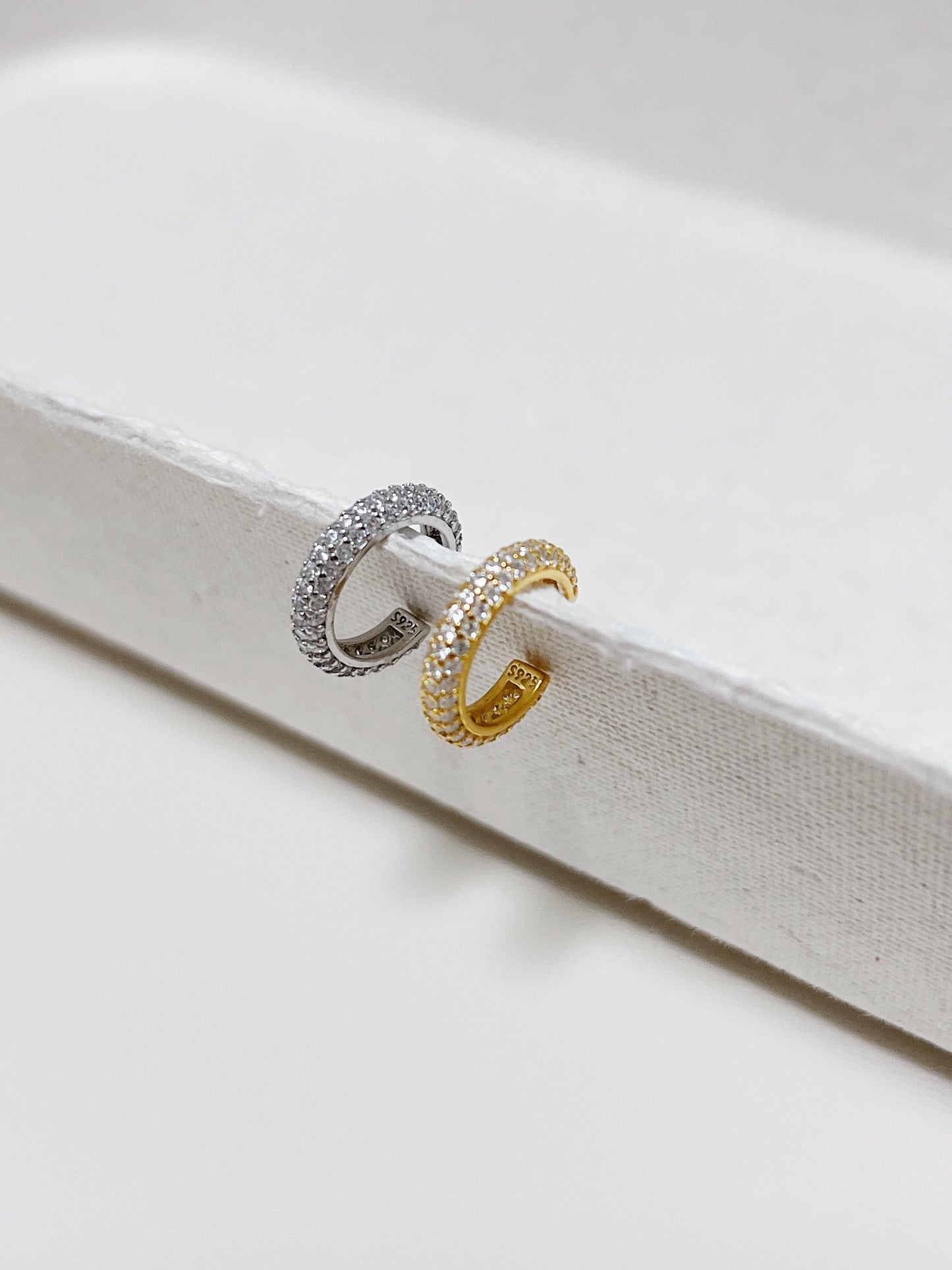 Side view of the S925 hallmark on the interior of the gold pavé cuff.