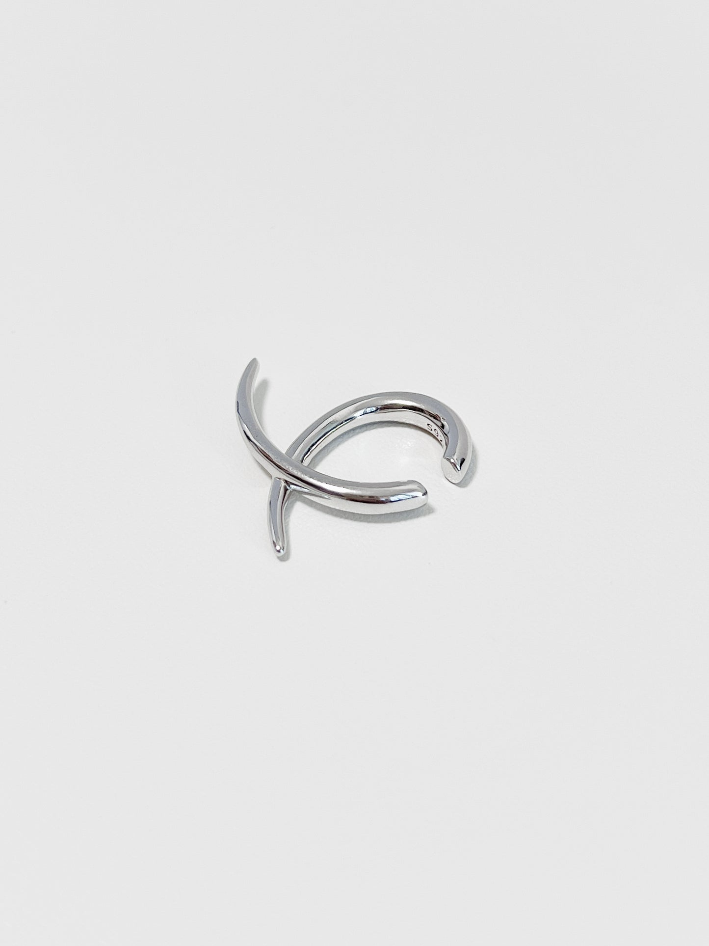 Side view of the Harley cuff showing the intersecting linear silhouette and polished finish.