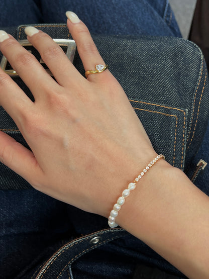 gold wave pinky ring paired with freshwater pearl tennis bracelet