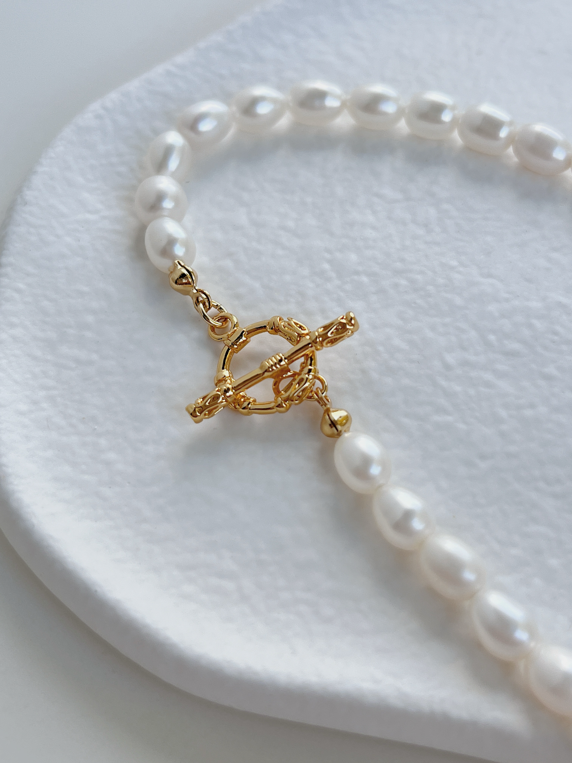 Close up macro shot of radiant baroque freshwater pearls on an 18k gold PVD tarnish resistant closure