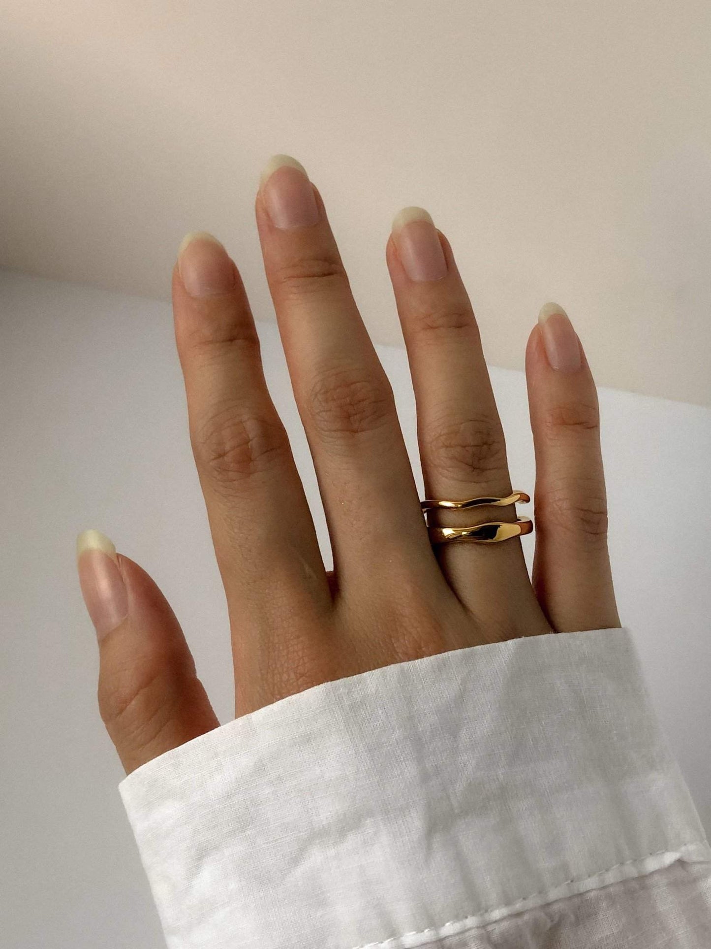 Close up of model hands showcasing comfortable fit of asymmetrical jewellery.
