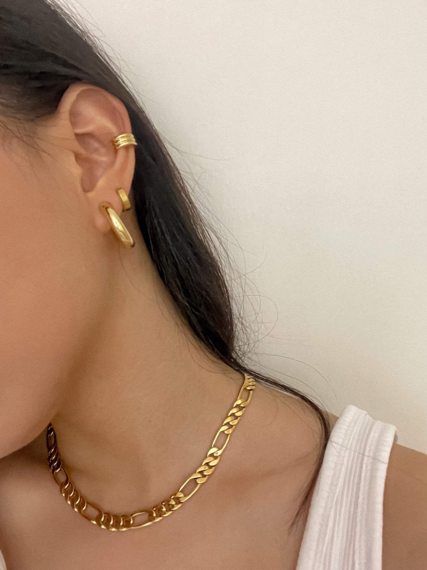 Side crop profile showing a clean comfort fit gold hoop clip sitting perfectly secure on a woman