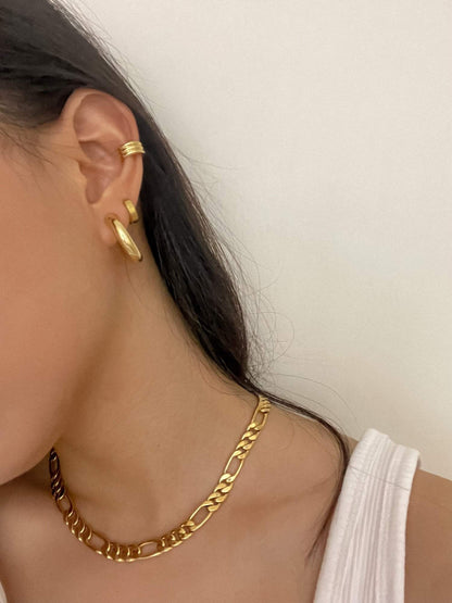 Side crop profile showing a clean comfort fit gold hoop clip sitting perfectly secure on a woman