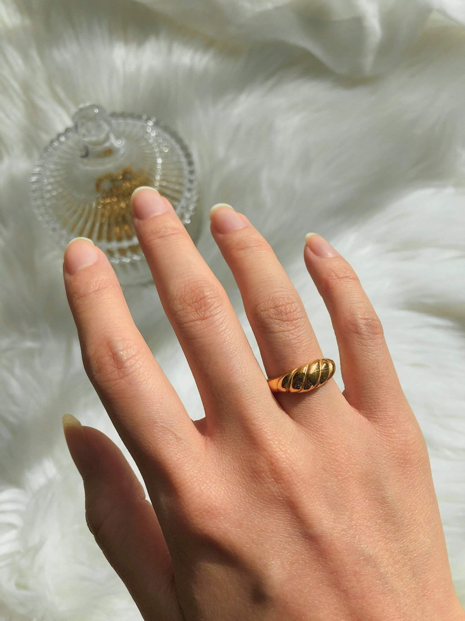 Editorial hand shot showcasing US size 5 gold ring styling