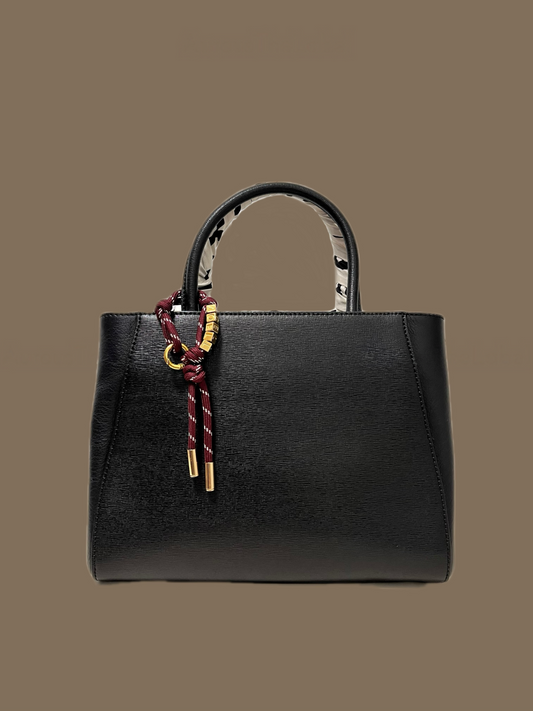 Aurous Atelier Personalized name cord bag charm with gold stainless steel letters.