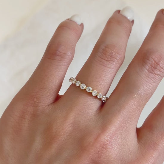 Macro close-up capturing the light reflecting off the brilliant-cut moissanite stones of the Callie gold micro-pave ring