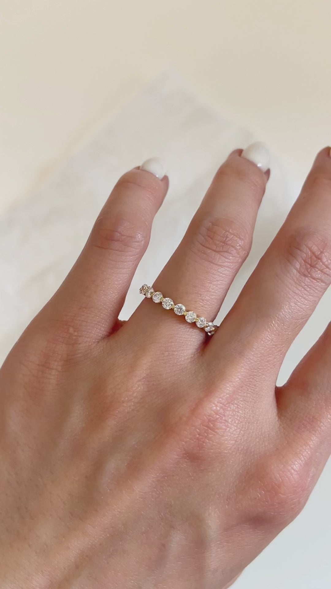 Macro close-up capturing the light reflecting off the brilliant-cut moissanite stones of the Callie gold micro-pave ring