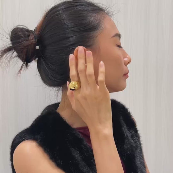 Model wearing Mylie hoops, sophisticated weave look.