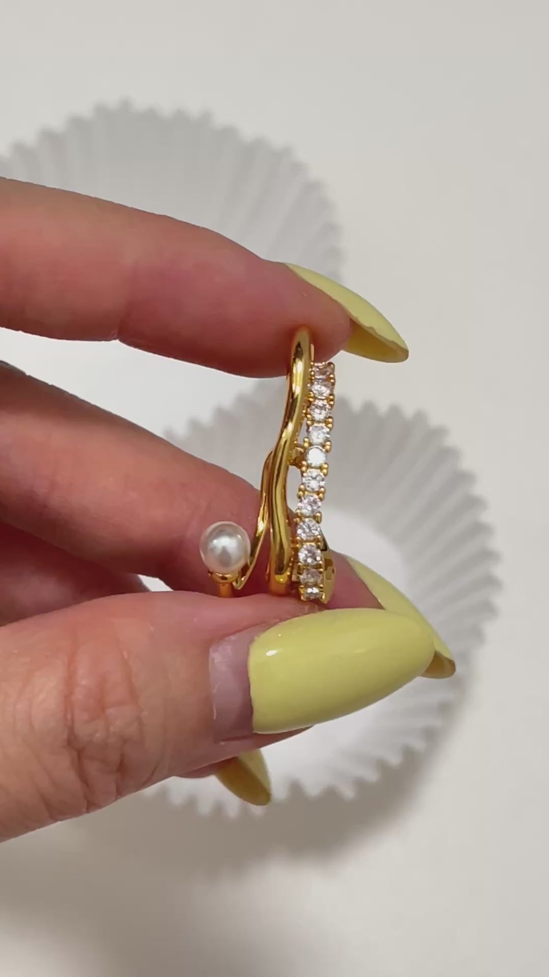 Detailed close-up angle of the dainty cassidy 18k Gold PVD Ear Cuff with a genuine round pearl and a row of shimmering cubic zirconia, displaying fine craftsmanship.