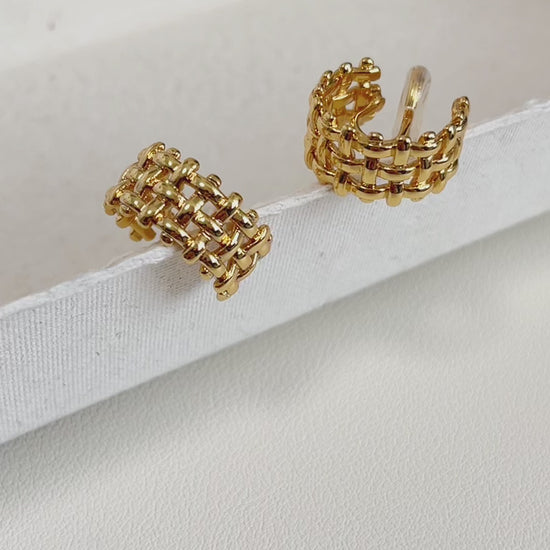 Macro shot of high-polish gold weave detail.