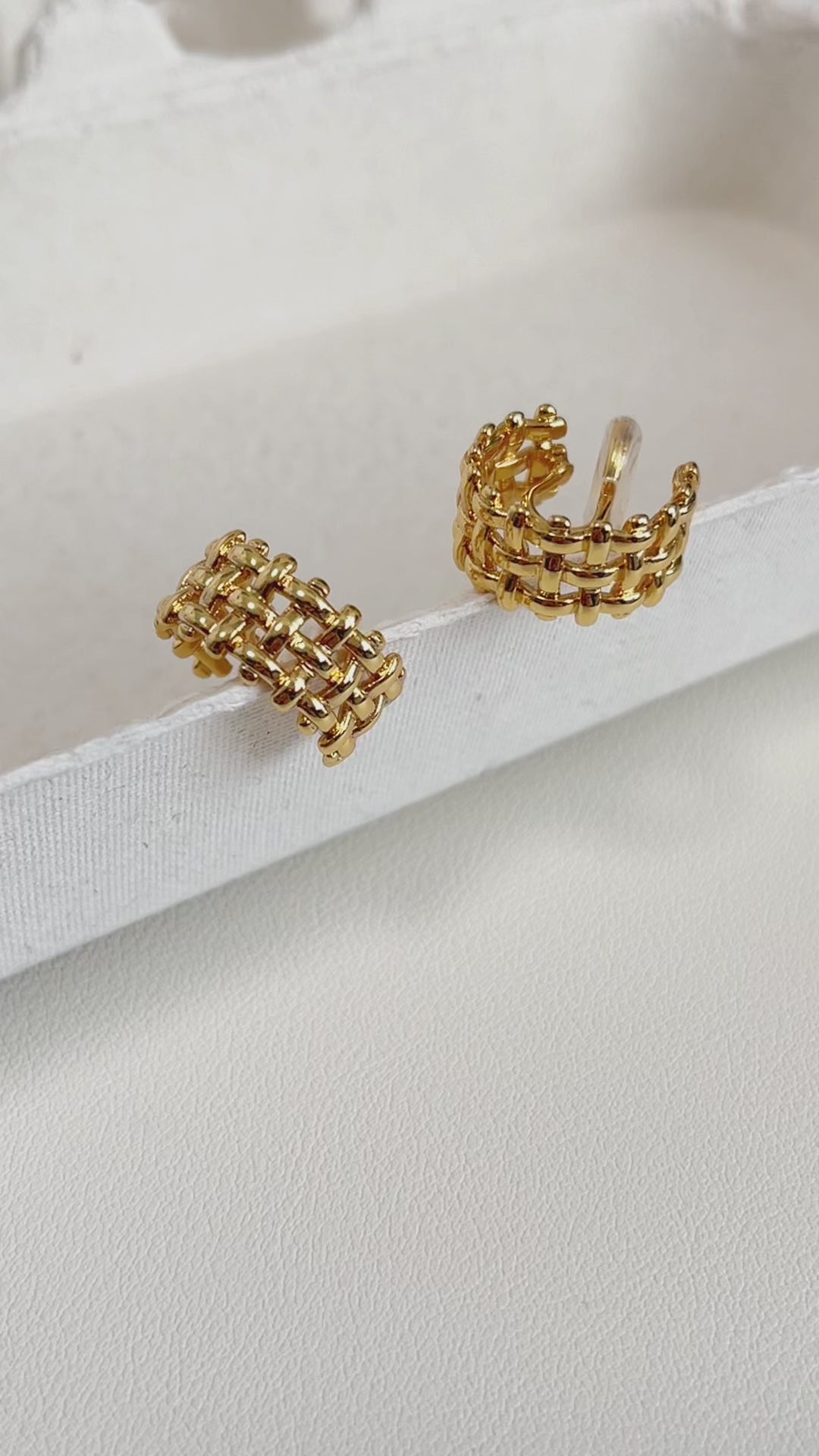 Macro shot of high-polish gold weave detail.