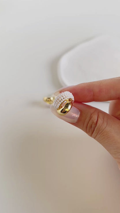 Contemporary luxury statement studs showcasing parallel gold and organic pearl tracks