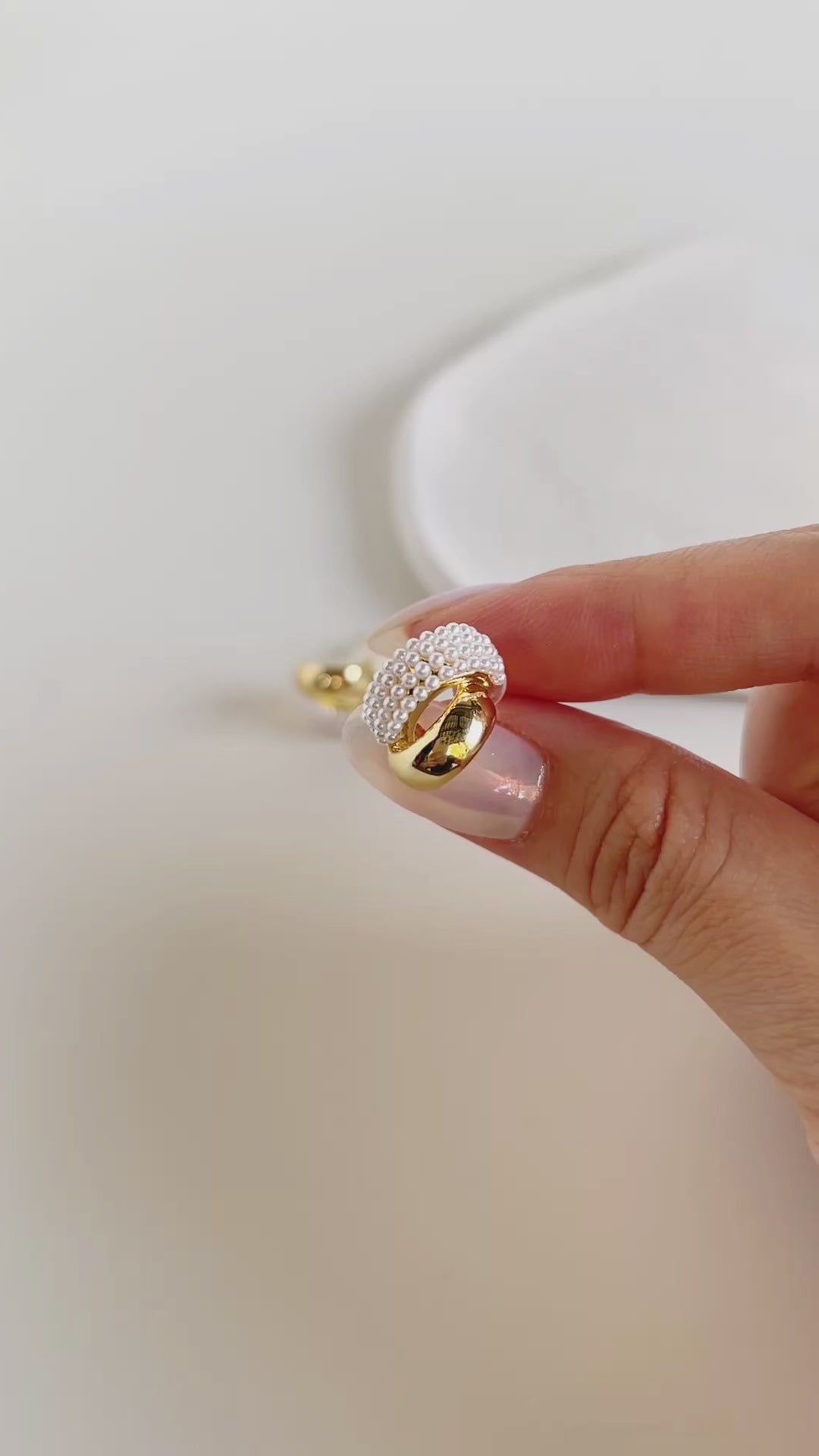 Contemporary luxury statement studs showcasing parallel gold and organic pearl tracks