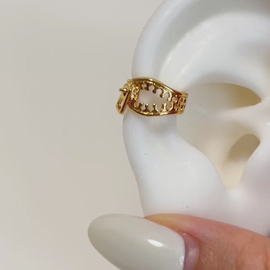 A video of gold zipper ear cuff showcasing on a white silicone ears